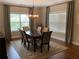 Elegant dining room features a chandelier, a dark wooden table, and large windows at 1790 Nestledown Dr, Cumming, GA 30040