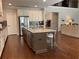 Spacious kitchen with granite counters, stainless appliances and views into the living room at 1790 Nestledown Dr, Cumming, GA 30040
