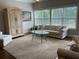Bright living room with large windows, neutral decor, and comfortable seating area at 1790 Nestledown Dr, Cumming, GA 30040