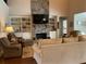 Cozy living room with a stone fireplace, built-in bookshelves, and comfortable seating at 1790 Nestledown Dr, Cumming, GA 30040