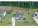 Aerial view of the home featuring a driveway and landscaping with a fire pit area at 411 Oakleigh Ave, Woodstock, GA 30188