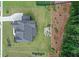 Aerial view showcasing the house, fire pit, expansive yard, and landscaping at 411 Oakleigh Ave, Woodstock, GA 30188