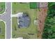 Aerial view of home with landscaped yard, long driveway, patio with fire pit and wooded area at 411 Oakleigh Ave, Woodstock, GA 30188