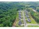 Aerial view of new construction homes with manicured lawns in a wooded neighborhood at 411 Oakleigh Ave, Woodstock, GA 30188