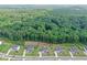 Aerial view of a house in a lushly forested neighborhood with a pond at 411 Oakleigh Ave, Woodstock, GA 30188