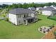 Spacious backyard with a well-maintained lawn and an outdoor stone fire pit area at 411 Oakleigh Ave, Woodstock, GA 30188