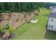 Backyard with terraced landscaping, a stone retaining wall, and a cozy fire pit area at 411 Oakleigh Ave, Woodstock, GA 30188