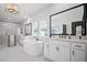 Lavish bathroom featuring double vanity sinks, free standing tub, and walk in shower at 411 Oakleigh Ave, Woodstock, GA 30188