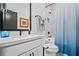 Cozy bathroom with a shower-tub, and updated white vanity with sleek fixtures at 411 Oakleigh Ave, Woodstock, GA 30188