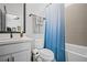 Full bathroom with tile surround and modern finishes at 411 Oakleigh Ave, Woodstock, GA 30188