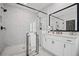 Bright bathroom featuring a walk-in shower and vanity with modern finishes at 411 Oakleigh Ave, Woodstock, GA 30188
