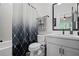 Bright bathroom featuring a shower with geometric curtain and updated vanity with sleek fixtures at 411 Oakleigh Ave, Woodstock, GA 30188