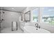 Bright bathroom featuring a soaking tub, walk-in shower, double vanity, and modern finishes at 411 Oakleigh Ave, Woodstock, GA 30188