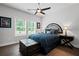 Comfortable bedroom with dark wood floors, a ceiling fan, and bright natural lighting at 411 Oakleigh Ave, Woodstock, GA 30188