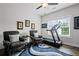 Bonus room featuring a treadmill, 2 leather chairs, and large windows at 411 Oakleigh Ave, Woodstock, GA 30188