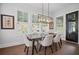 Cozy dining area with natural light and views of the outdoors through large windows at 411 Oakleigh Ave, Woodstock, GA 30188