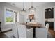 Charming dining area with modern chandeliers and a view into the adjacent butler's pantry at 411 Oakleigh Ave, Woodstock, GA 30188