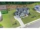 Aerial view of home with landscaped yard, long driveway, patio with fire pit and wooded area at 411 Oakleigh Ave, Woodstock, GA 30188