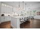 Open concept kitchen featuring a large island, pendant lighting and a view of the dining area at 411 Oakleigh Ave, Woodstock, GA 30188