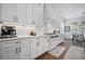 Contemporary kitchen showcasing white cabinetry, stainless steel appliances, and a cozy breakfast nook at 411 Oakleigh Ave, Woodstock, GA 30188