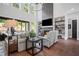 Cozy living room featuring a stone fireplace, high ceilings, and comfortable seating arrangements at 411 Oakleigh Ave, Woodstock, GA 30188