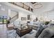 Open-concept living room with high ceilings, hardwood floors, and a view of the gourmet kitchen at 411 Oakleigh Ave, Woodstock, GA 30188