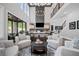 Spacious living room with a stone fireplace, high ceilings, and comfortable seating arrangements at 411 Oakleigh Ave, Woodstock, GA 30188