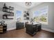 Bright home office with natural light, custom shelving, and a dark wood executive desk at 411 Oakleigh Ave, Woodstock, GA 30188