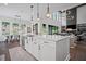 Open floorplan from kitchen to living room, with hardwood floors, high ceilings and natural light at 411 Oakleigh Ave, Woodstock, GA 30188