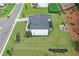 Aerial view of the backyard, featuring a fire pit, large lawn, and landscaping at 411 Oakleigh Ave, Woodstock, GA 30188