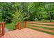 Back deck overlooking a grassy backyard, surrounded by mature trees and landscaping at 4200 Sterling Pointe Dr, Douglasville, GA 30135