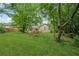 Backyard view of home with a deck, grassy lawn, landscaping and mature trees offering privacy at 4200 Sterling Pointe Dr, Douglasville, GA 30135