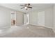 Spacious bedroom showcasing neutral walls, carpeted floors, and two entry doors at 4200 Sterling Pointe Dr, Douglasville, GA 30135