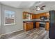 Kitchen with oak cabinetry, stainless steel appliances, and modern lighting at 4200 Sterling Pointe Dr, Douglasville, GA 30135
