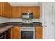 Up-close view of the kitchen's gas range, microwave, and wood cabinets at 4200 Sterling Pointe Dr, Douglasville, GA 30135