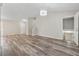 Spacious living room features wood-look flooring, a modern chandelier, and staircase at 4200 Sterling Pointe Dr, Douglasville, GA 30135