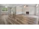 Open concept living room with vaulted ceilings, a fireplace, and wood-look flooring at 4200 Sterling Pointe Dr, Douglasville, GA 30135