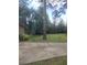 Front yard featuring mature trees, grass and concrete driveway at 1195 Christian Circle, Conyers, GA 30013
