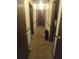 Hallway with neutral walls, carpeting and dark stained trim, connecting various rooms in the house at 1195 Christian Circle, Conyers, GA 30013