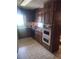 Traditional kitchen features wooden cabinets, double ovens, tile floors and laminate countertops at 1195 Christian Circle, Conyers, GA 30013