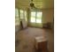 Enclosed sunroom with large windows, ceiling fan, and neutral carpet; ready for your personal touches at 1195 Christian Circle, Conyers, GA 30013