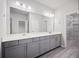 Bathroom featuring a double sink vanity, large mirror, and a walk-in closet at 1505 Slopeside Loop, Smyrna, GA 30082