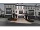 Modern townhome featuring light brick, a one-car garage, and manicured landscaping at 1505 Slopeside Loop, Smyrna, GA 30082