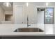 Close up of a sleek kitchen island with stainless steel sink and quartz countertops at 1505 Slopeside Loop, Smyrna, GA 30082