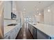 Galley kitchen featuring stainless steel appliances, white cabinets, and a large kitchen island at 1505 Slopeside Loop, Smyrna, GA 30082