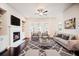 Cozy living room featuring a fireplace, built-in shelves, and access to a balcony at 1505 Slopeside Loop, Smyrna, GA 30082
