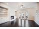 Open living space with hardwood floors, fireplace, and balcony doors at 1505 Slopeside Loop, Smyrna, GA 30082