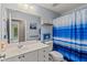 Stylish bathroom features a vanity, toilet, and shower with a blue and white striped curtain at 5832 Sycamore Ridge Dr, Sugar Hill, GA 30518