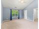 Spacious bedroom with vaulted ceiling, large window, plush carpet and neutral paint at 5832 Sycamore Ridge Dr, Sugar Hill, GA 30518