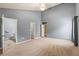 Bedroom with neutral paint, carpet, and a view into the en suite bathroom at 5832 Sycamore Ridge Dr, Sugar Hill, GA 30518